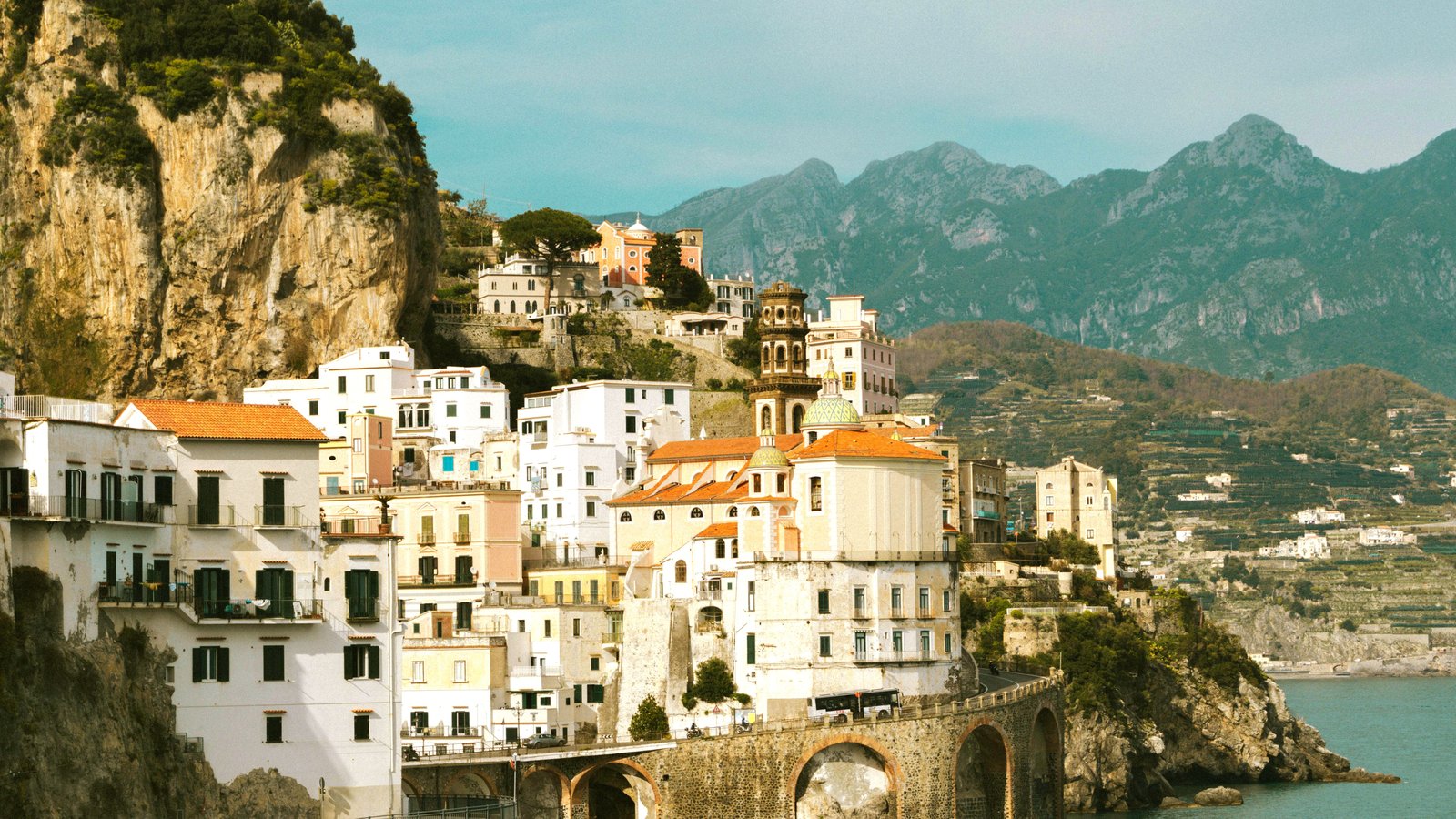 Amalfi Coast pastel towns on cliffs above turquoise sea