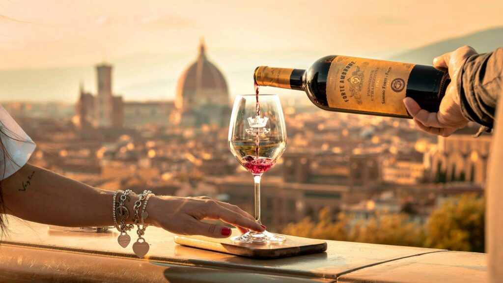 Couple toasting with red wine overlooking Florence skyline at sunset