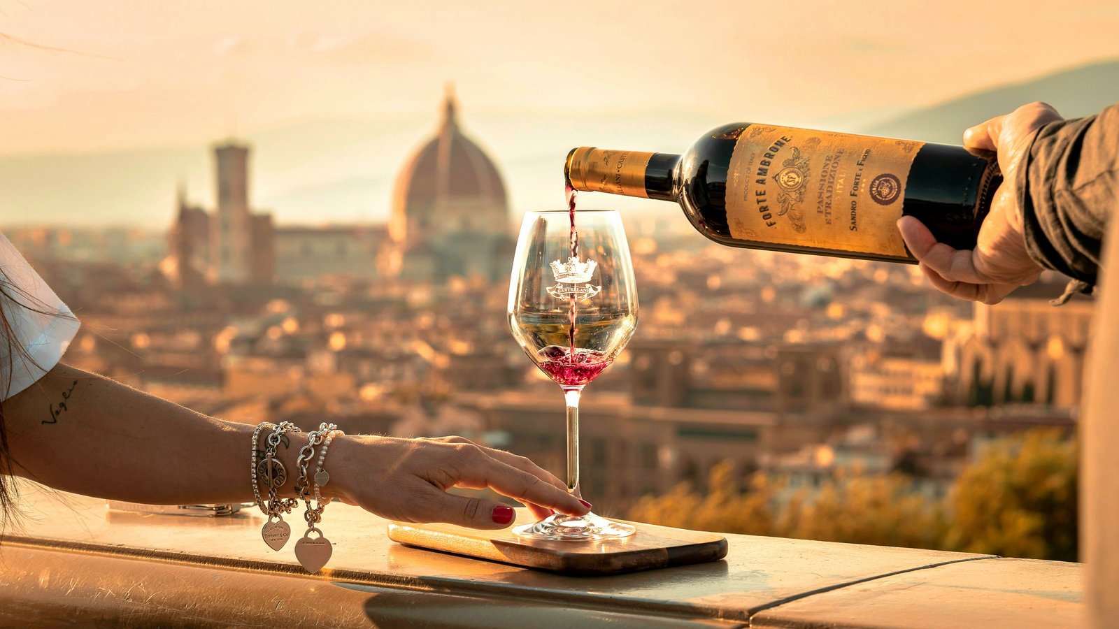12 Most Romantic Destinations in Europe Couple toasting with red wine overlooking Florence skyline at sunset
