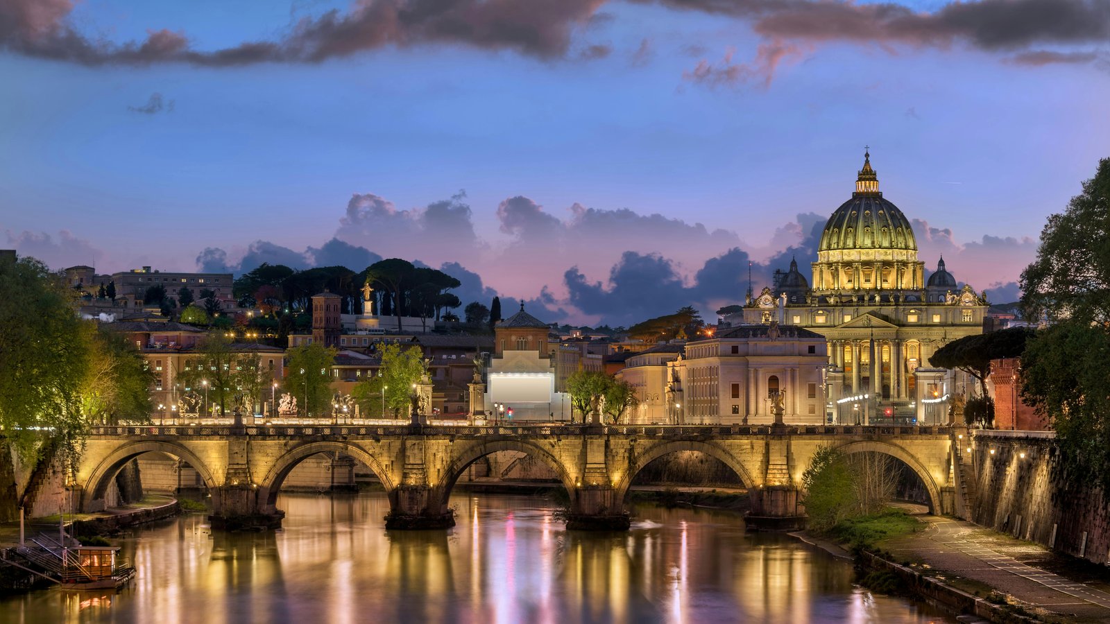 12 Most Romantic Destinations in Europe St. Peter’s Basilica and Ponte Sant’Angelo bridge at sunset in Rome, Italy