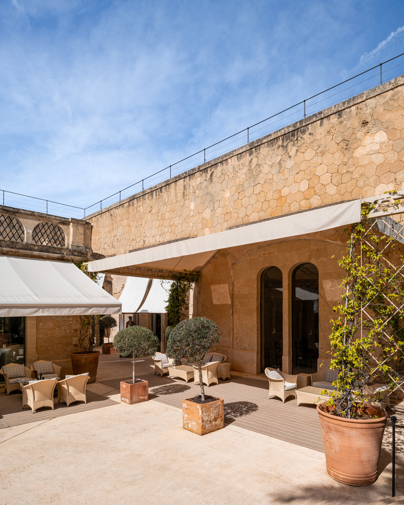 Shaded outdoor seating terrace at Cap Rocat hotel in Mallorca