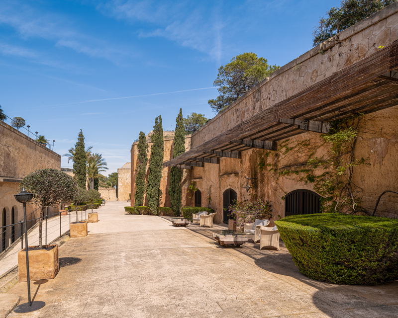 Sunlit stone walkway inside Cap Rocat fortress hotel in Mallorca