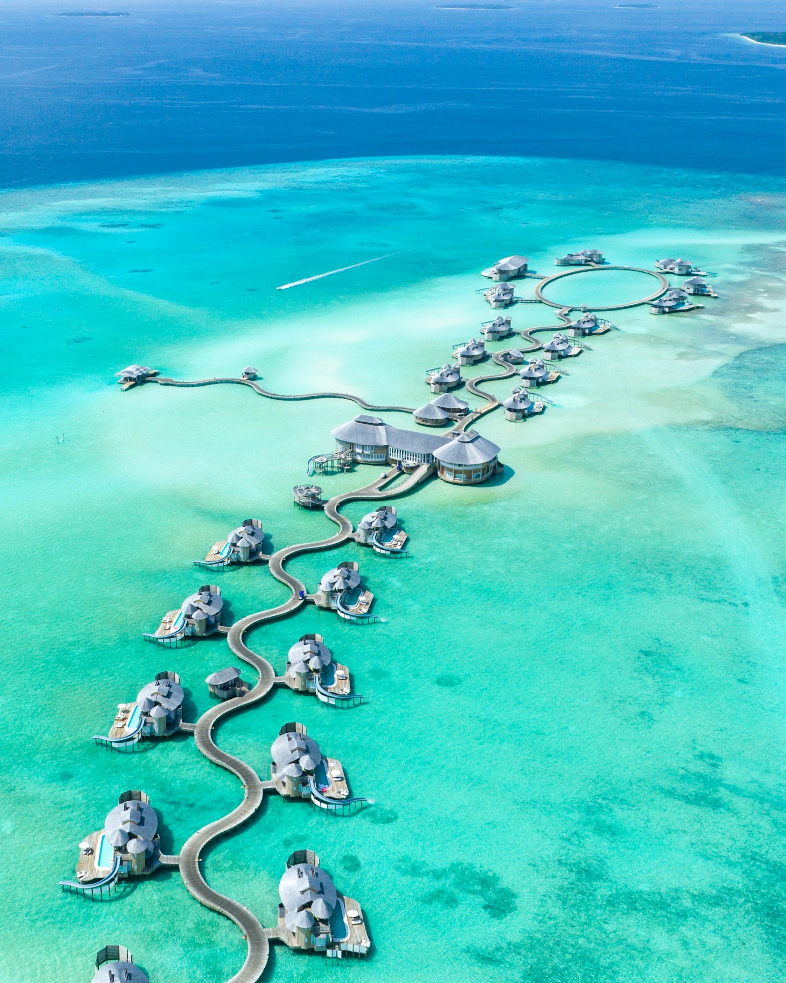 Aerial view of Soneva Jani's overwater villas and lagoon walkways