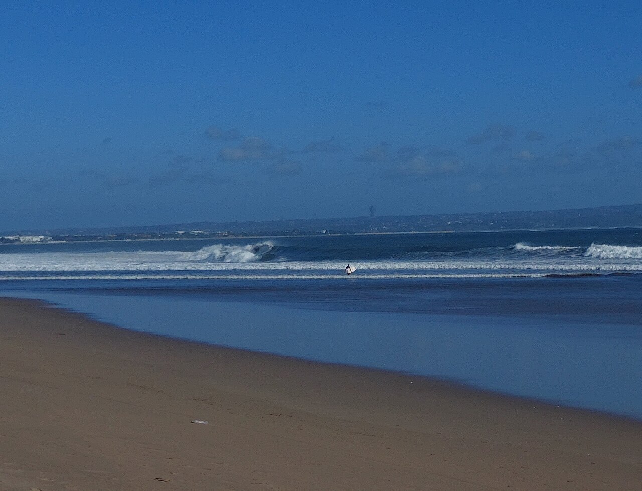 Seminyak beach coastline in Bali with view toward Bukit peninsula