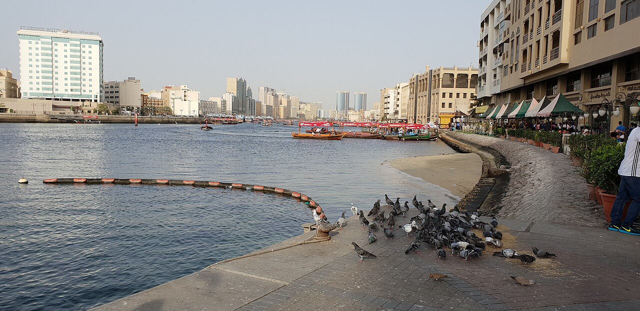 Dubai Creek, historic Dubai buildings along the water with modern buildings beyond