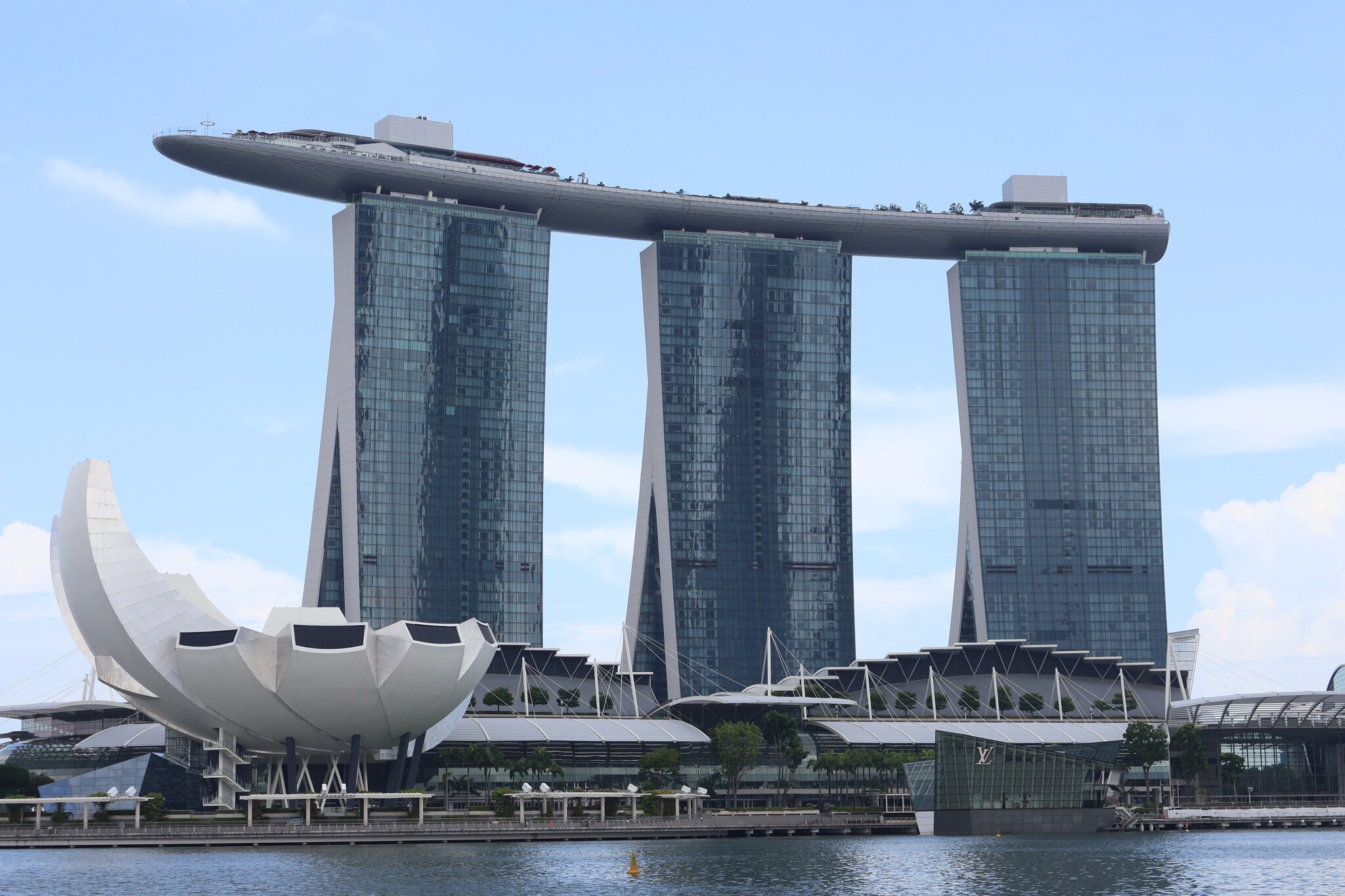Marina Bay Sands hotel towers and the ArtScience Museum along Singapore waterfront in daylight